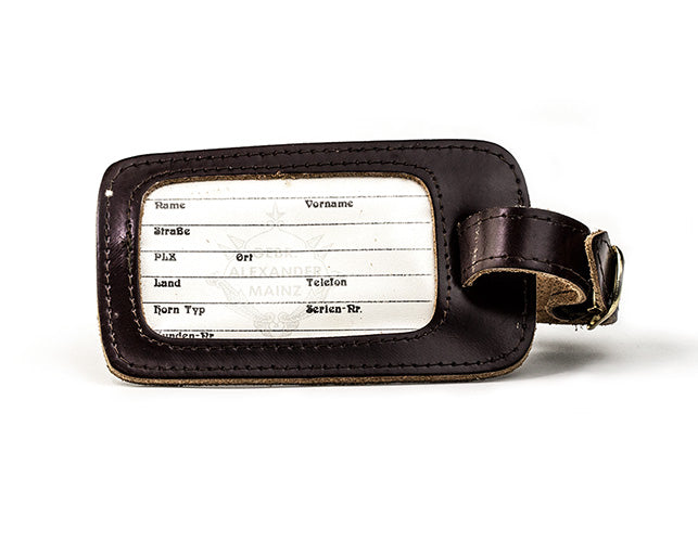 Close-up of a sturdy luggage tag designed for French horn cases.